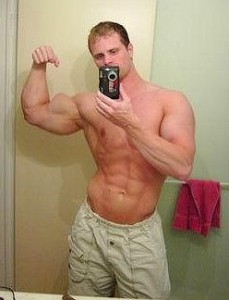 guy taking a pircture of himself flexing in mirror